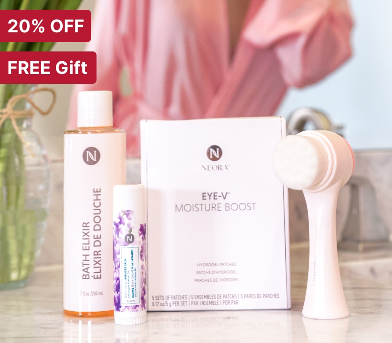 Neora’s Make her Mother’s Day Bundle featuring bestselling Eye-V Moisture Boost Hydrogel Patches, Zen + Calm Lavender Balm, Bath Elixir and FREE dual-sided Facial Brush sitting on a bathroom counter